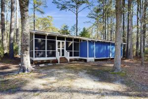 a blue house in the middle of a forest at Middlesex Beach - 9 Bridge in Bethany Beach