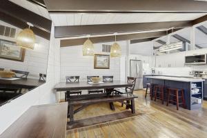 a large kitchen with a wooden table in a room at Middlesex Beach - 9 Bridge in Bethany Beach