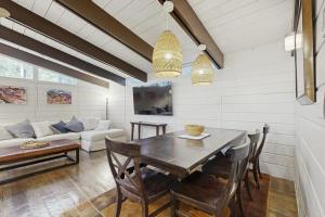 a dining room with a table and a couch at Middlesex Beach - 9 Bridge in Bethany Beach +17 photos