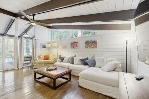 a living room with a white couch and a table at Middlesex Beach - 9 Bridge in Bethany Beach