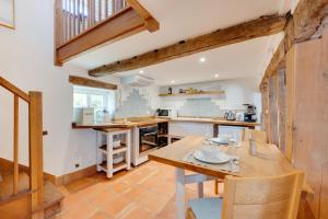 a kitchen with a wooden table and chairs in a room at 2 Bed in Walsham-le-Willows oc-gabpla in Walsham le Willows +1 photo