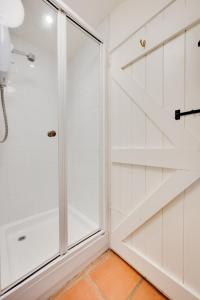 a shower with a glass door in a bathroom at 2 Bed in Walsham-le-Willows oc-gabpla in Walsham le Willows