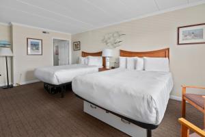 a hotel room with two beds and a chair at Desert Sand Resort in Avalon +46 photos