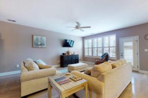 a living room with two couches and a table at Bishops Landing -- 16985 Bellevue in Millville