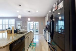 a large kitchen with a refrigerator and a sink at Bishops Landing -- 16985 Bellevue in Millville
