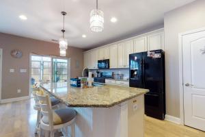 a kitchen with a counter and a black refrigerator at Bishops Landing -- 16985 Bellevue in Millville