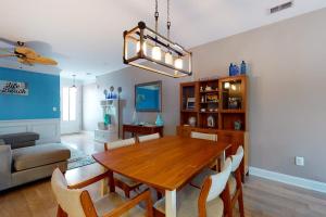 a dining room with a table and a couch at Bishops Landing -- 16985 Bellevue in Millville