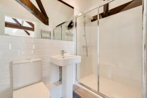 a bathroom with a toilet and a sink and a shower at High Mill in Beadnell +30 photos