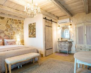 a bedroom with a bed and a table at Maison Bagatell Badacsony in Badacsonytomaj