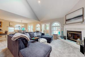 a living room with a couch and a fireplace at Salt Pond --- 494 Bethany Loop in Bethany Beach