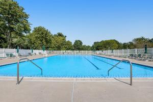 a large swimming pool with blue water at Salt Pond --- 494 Bethany Loop in Bethany Beach