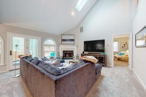 a living room with a couch and a tv at Salt Pond --- 494 Bethany Loop in Bethany Beach