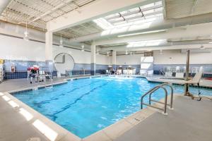 a large swimming pool with blue water in a building at Sea Colony - 904 Dover House Rd in Bethany Beach