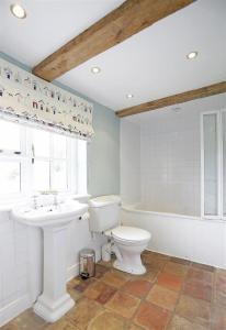 a bathroom with a toilet and a sink and a tub at 5 Bed in Beccles oc-ksf in Wangford +25 photos
