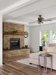a living room with a stone fireplace and a couch at Mountain View Home on 2 Acres in Bozeman