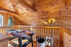 a log cabin with a table and a lamp at Cupids Retreat in Boone