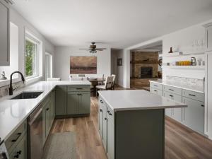 a kitchen with white counter tops and a dining room at Mountain View Home on 2 Acres in Bozeman