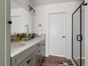 a white bathroom with two sinks and a mirror at Mountain View Home on 2 Acres in Bozeman +41 photos
