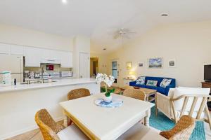 a kitchen and living room with a table and chairs at Sea Colony - 7903 Timberlake in Bethany Beach