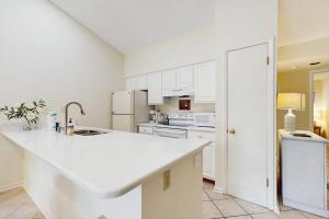 a kitchen with white cabinets and a white counter top at Sea Colony - 7903 Timberlake in Bethany Beach