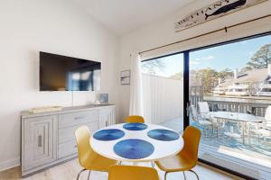 a dining room with a white table and chairs at Sea Colony West Pine in Bethany Beach