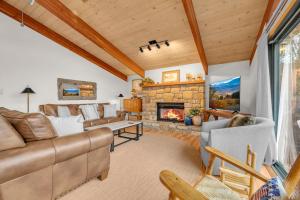 a living room with a couch and a fireplace at Heavens Door in Beech Mountain