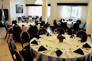 a group of tables and chairs in a room at Hathor Hotels Mendoza in Mendoza
