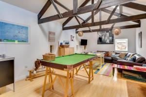 a living room with a pool table in it at Moo House in Beadnell
