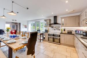 a kitchen with a table and a dining room at Moo House in Beadnell