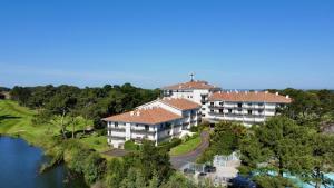 an aerial view of a large house next to a river at Chiberta Ocean & Golf Suite in Anglet
