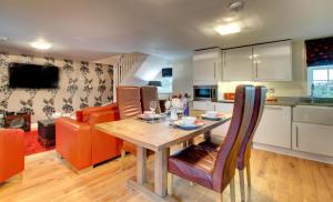 a kitchen and living room with a wooden table and chairs at 2 Bed in Belford oc-gd1023 in Warenford