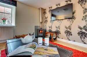 a living room with a book and a fireplace at 2 Bed in Belford oc-gd1023 in Warenford