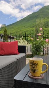 a yellow coffee cup sitting on top of a table at Jovanov Residence - the Landscape Beauty in Dolna Matka