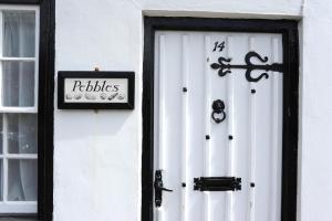 a white door with a sign on the side of a building at 1 Bed in Southwold oc-aapebb in Southwold