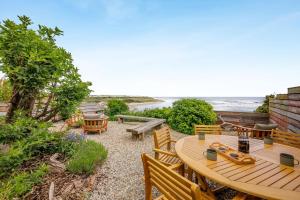 a patio with a table and chairs and the beach at Boca Chica Cottage in Cambois