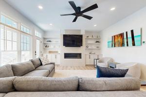 a living room with a couch and a ceiling fan at The Peninsula --- 33129 Serenity Circle #87 in Millsboro
