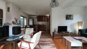 a living room with a couch and a table with chairs at Jovanov Residence - the Landscape Beauty in Dolna Matka +34 photos