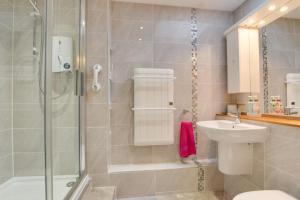 a bathroom with a shower and a toilet and a sink at Becws Clyd in Trawsfynydd +40 photos
