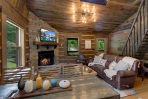 a living room with a couch and a fireplace at Eagle Ridge Creek in Banner Elk