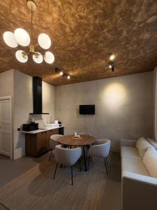 a living room with a table and a couch at Buntes nams l Self check-in l Private entrance in Limbaži