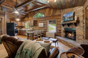 a living room with a fireplace in a log home at Eagle Ridge Creek in Banner Elk