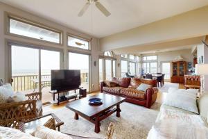 a living room with a couch and a tv at Seatowne - 36912 Bayside in Fenwick Island