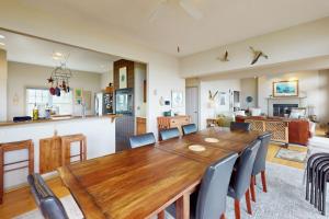 a dining room and kitchen with a wooden table and chairs at Seatowne - 36912 Bayside in Fenwick Island