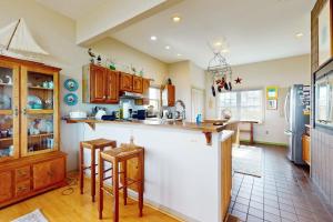a kitchen with wooden cabinets and a counter top at Seatowne - 36912 Bayside in Fenwick Island