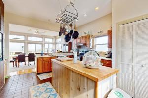 a kitchen with a counter and a dining room at Seatowne - 36912 Bayside in Fenwick Island +17 photos