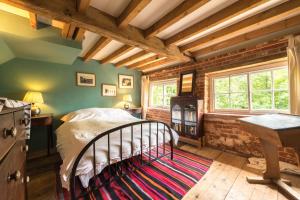 a bedroom with a bed in a room with green walls at 4 Bed in Reepham oc-497 in Reepham