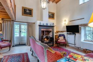 a living room with a fireplace and a tv at 4 Bed in Reepham oc-497 in Reepham