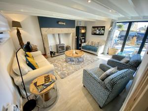a living room with two couches and a table at Red Herring in Craster