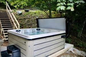 a bath tub sitting next to some stairs at Whiskey Ridge in Boone