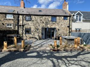 an old stone building with a gate in front of it at Red Herring in Craster